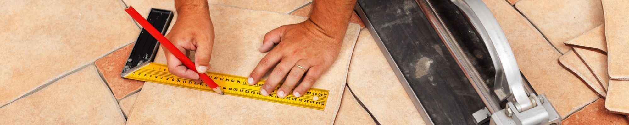 A contractor installing floor tiles